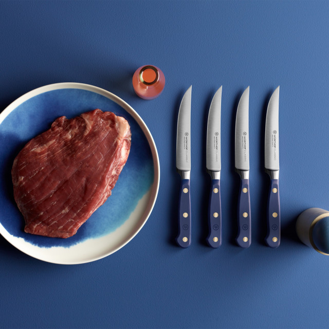 Wusthof Classic Colours Wild Blueberry Steak Knives Set, 4-Piece on the table with meat