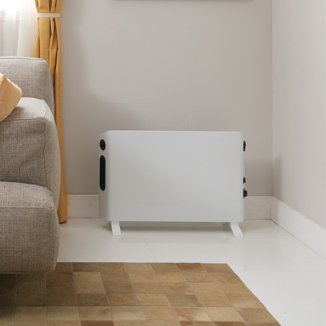 DeLonghi Slim Style Convector Heater with Fan, 2000W in the living room again the wall