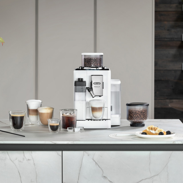 DeLonghi Rivelia Bean to Cup Coffee Machine with Bean Switch - Arctic White with coffee cups on the kitchen counter