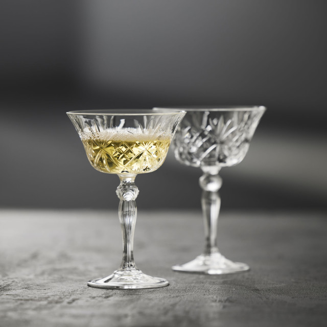 Lyngby Melodia Crystal Champagne Coupe Glasses, Set of 4 with champagne on the table