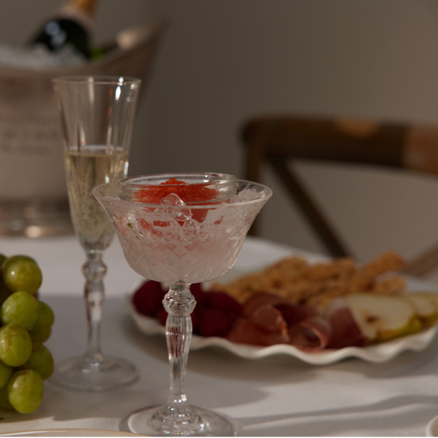 Lyngby Melodia Crystal Champagne Coupe Glasses, Set of 4 with champagne on the table
