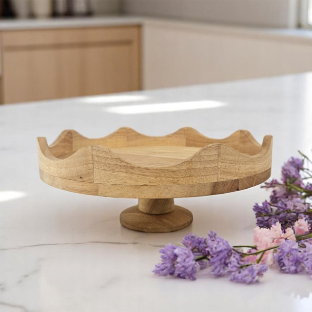 Nicolson Russell Scalloped Wooden Cake Stand, 30cm on the kitchen counter