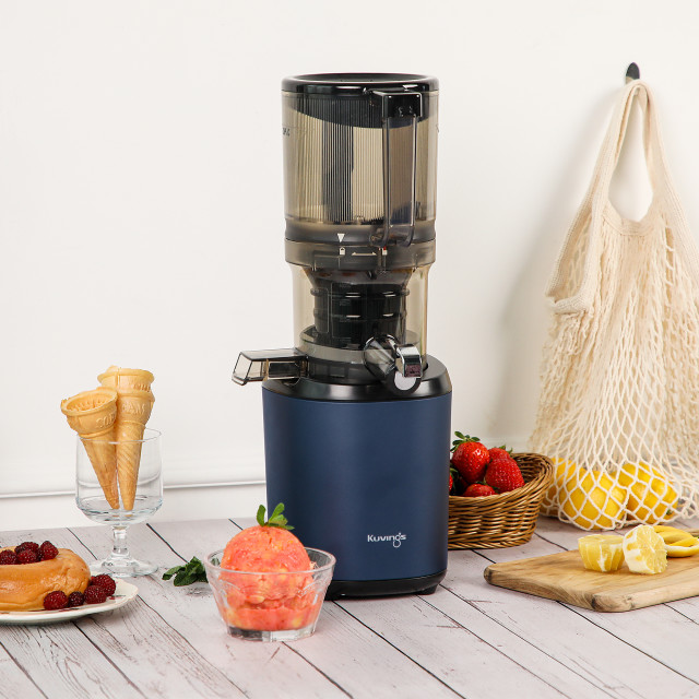 Kuvings Auto6 Cold Press Juicer - Navy on the table with fruits