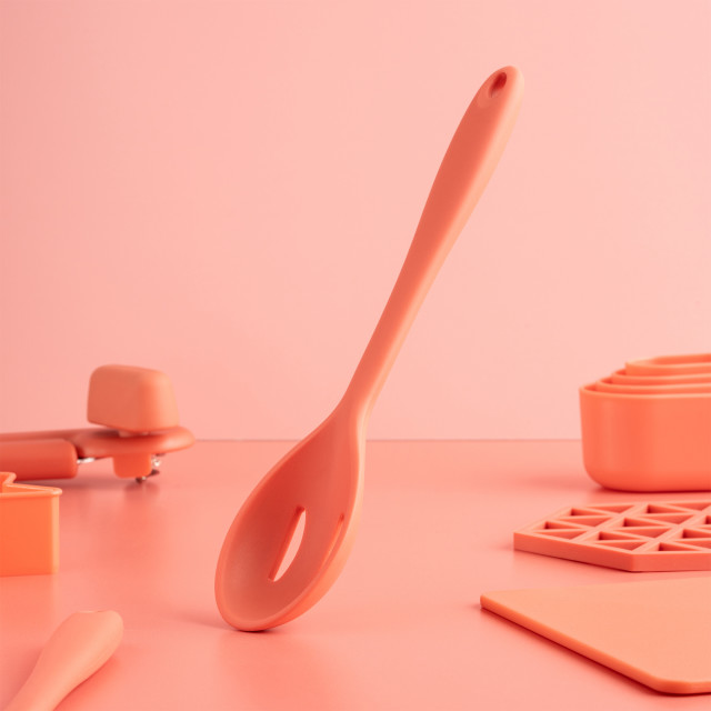 Fusion Twist Silicone Slotted Spoon - Coral on the table