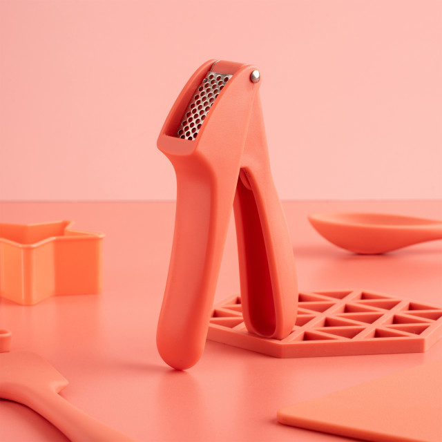 Fusion Twist Garlic Press - Grey on the table