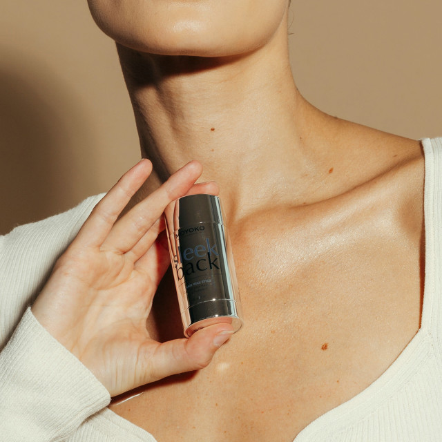 Moyoko Sleek Back Hair Wax Stick, 30g handheld showing scale