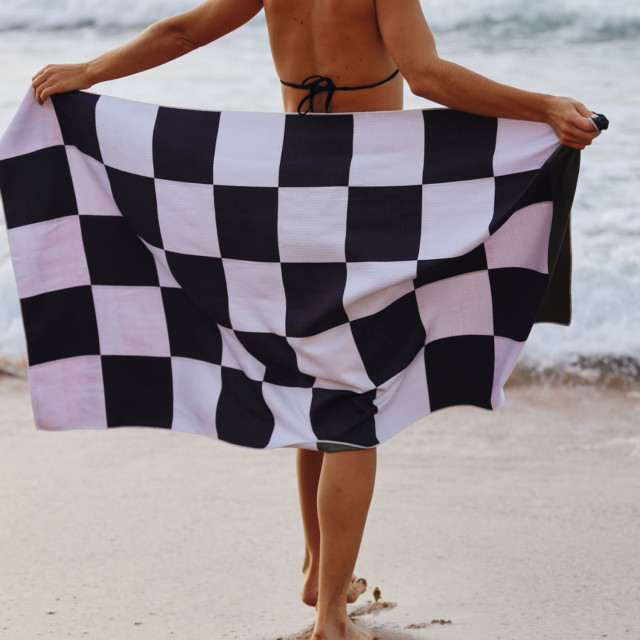 Saltii Kraalbaai Summer Waffle Beach Towel, 80cm x 160cm held at the beach