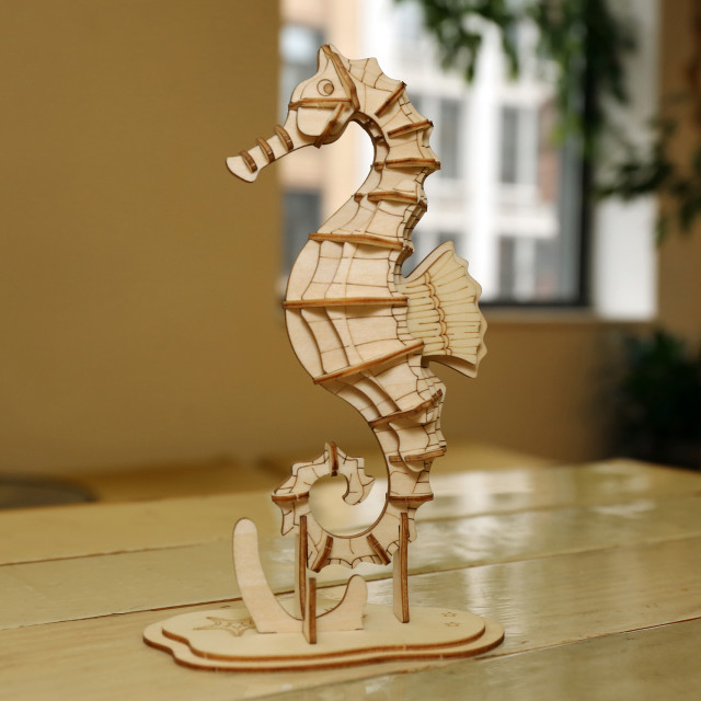 Kikkerland 3D Wooden Sea Horse Puzzle on the table