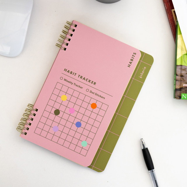 Kikkerland Habit Tracker Notebook on the table