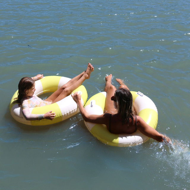 Sunnylife Slim Tube Pool Ring - Tides Out Citrus Stripe in the water