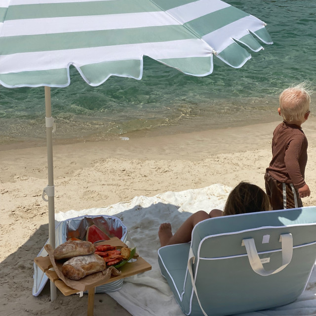 Sunnylife Compact Beach Umbrella - La Palma Sage Stripe at the beach