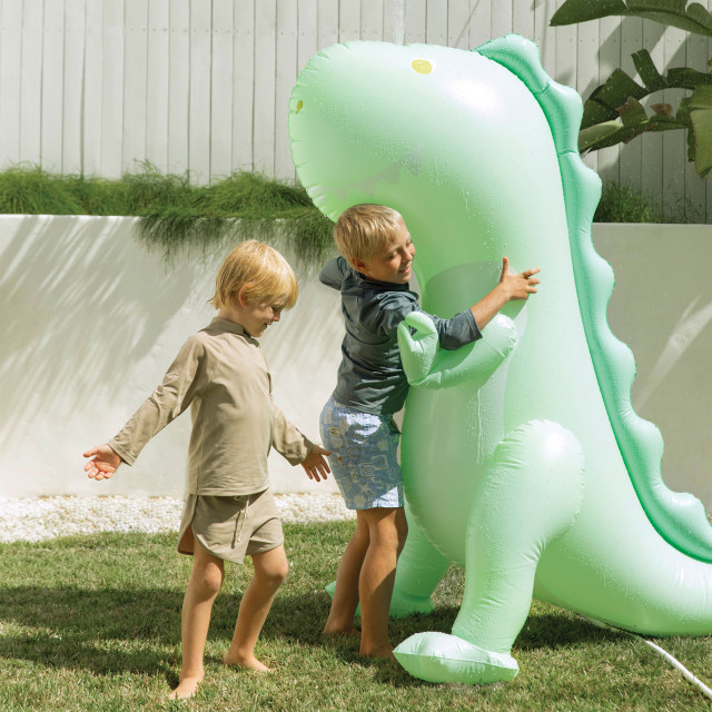 Sunnylife Surfing Dinosaur Giant Inflatable Sprinkler on the lawn