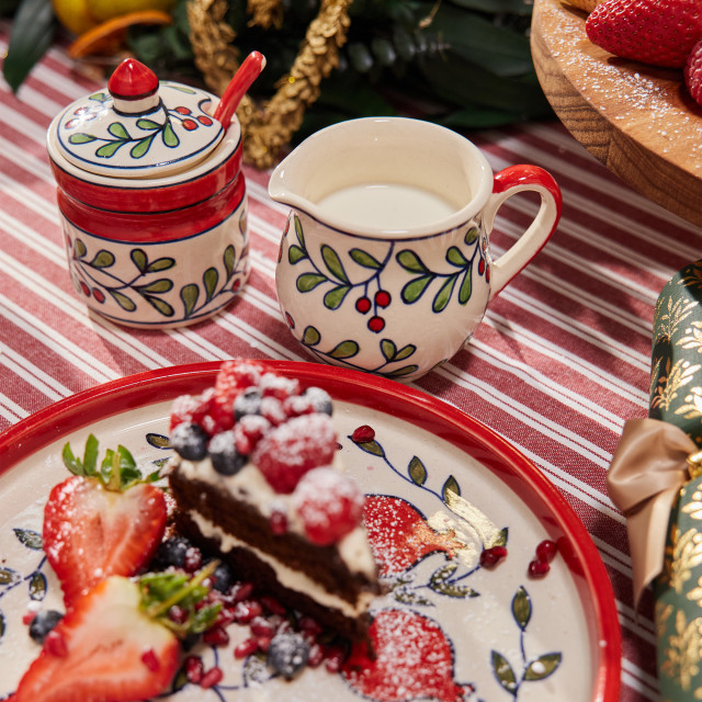 Humble & Mash Christmas Ceramic Sugar Bowl and Spoon, 8cm on a table with a slice of cake