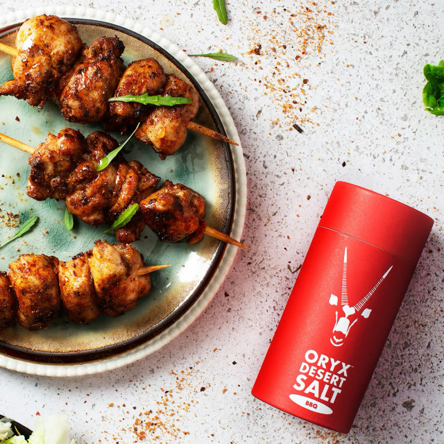 Oryx Desert Salt Oryx BBQ Salt in Biodegradable Shaker with food on the table