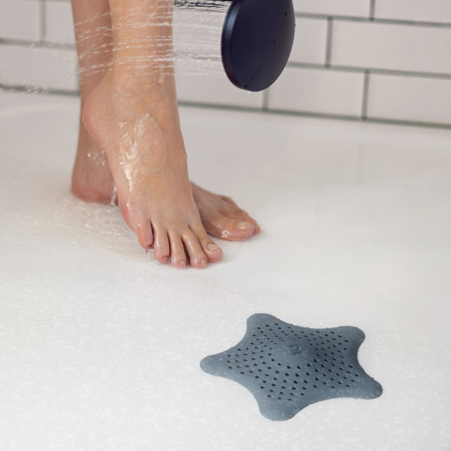 Umbra Starfish Hair Catcher - Slate Blue on a shower drain