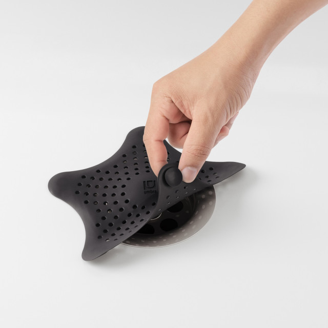 Umbra Starfish Hair Catcher - Black on a bathtub drain