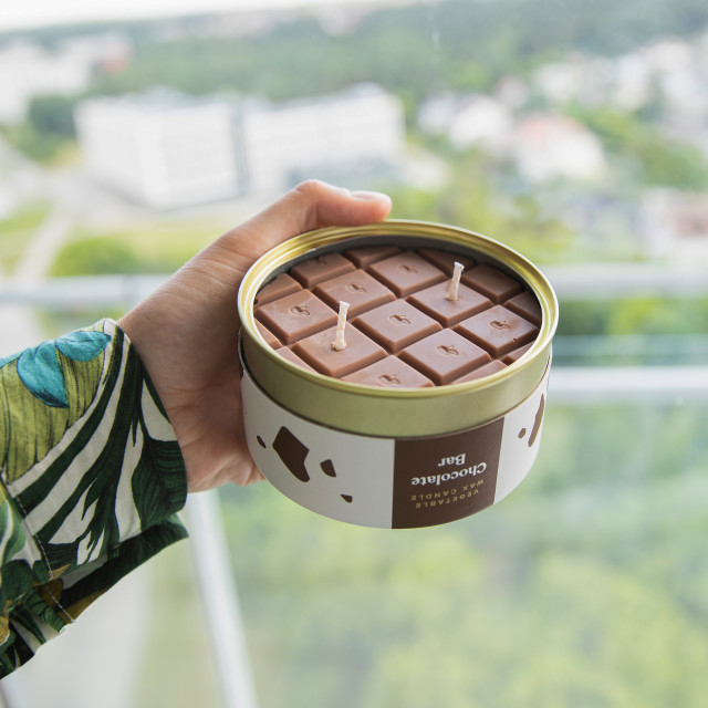 CandleCan Chocolate Bar Scented Candle handheld showing scale