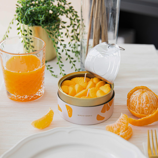 CandleCan Peeled Tangerines Scented Candle on a dinner table