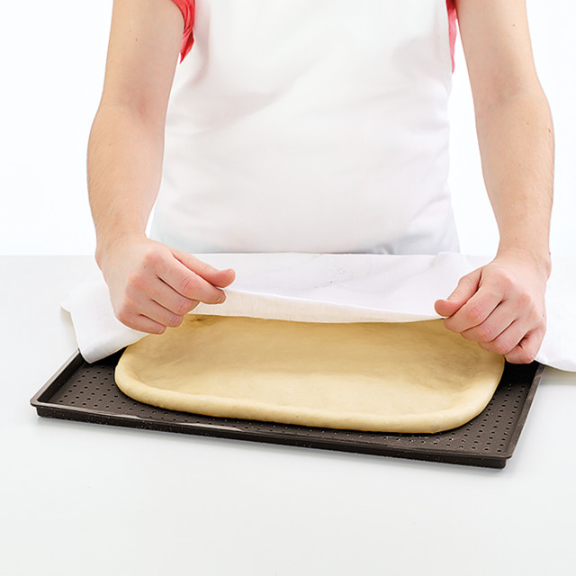 Lekue Silicone Rectangular Pizza Crisper Mat with pizza dough