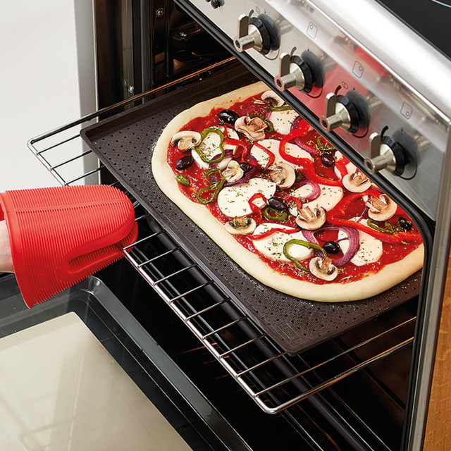 Lekue Silicone Rectangular Pizza Crisper Mat in an oven with pizza