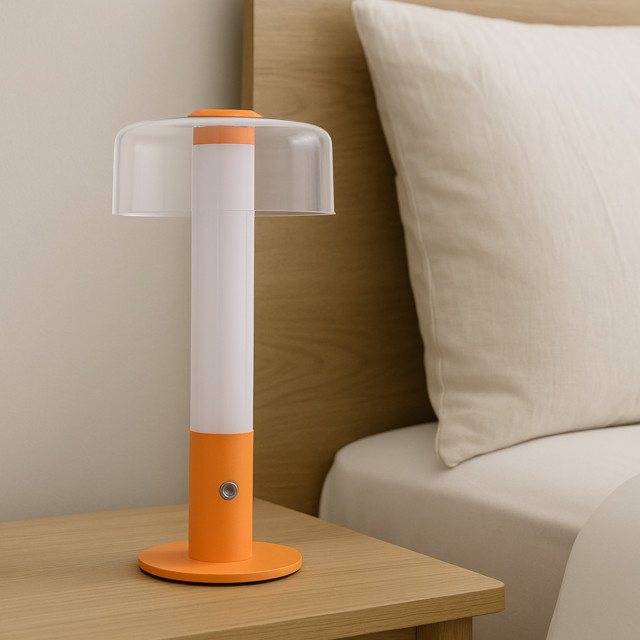 Arc & Hue Arcis Portable & Rechargeable LED Lamp - Orange on a nightstand