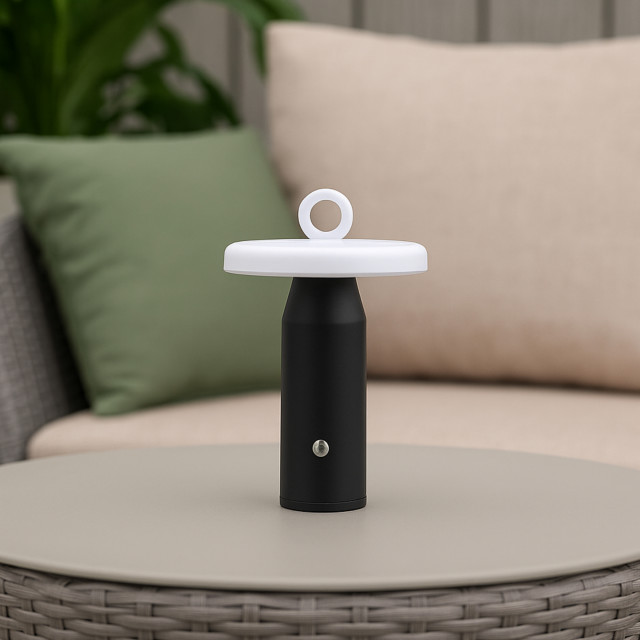 Arc & Hue Ella Portable & Rechargeable LED Outdoor Lamp - Black on a coffee table