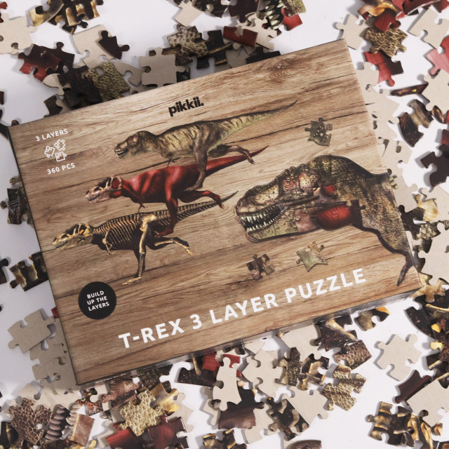 Pikkii T-Rex Layer Puzzle, 360-Piece on the table