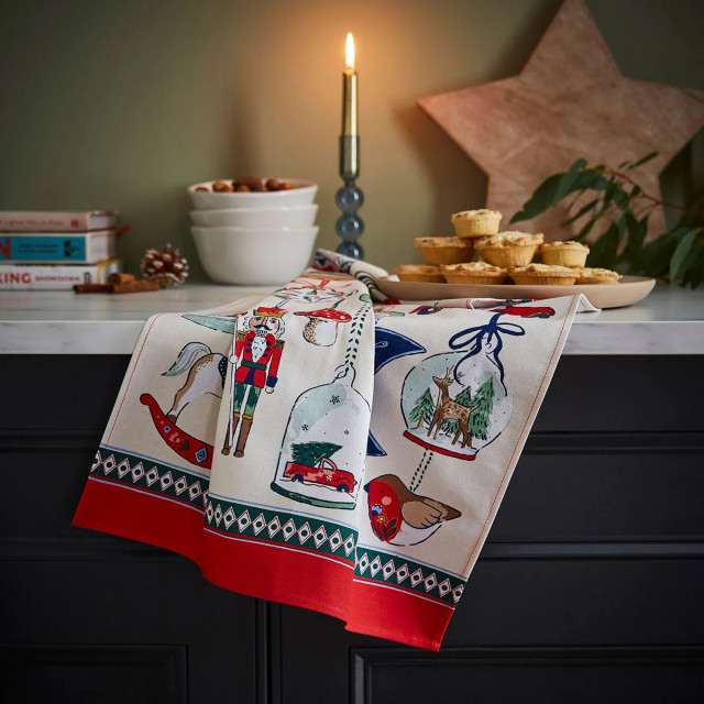 Ulster Weavers Christmas Ornaments Cotton Tea Towel on the kitchen counter