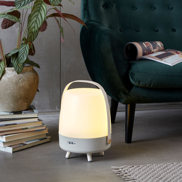 Kooduu Lite-Up Play JBL Speaker & Lamp - White/Sand next to a couch