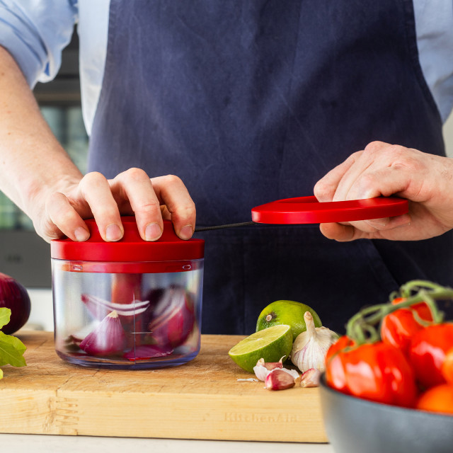 KitchenAid Hand Pull Food Chopper with red onion
