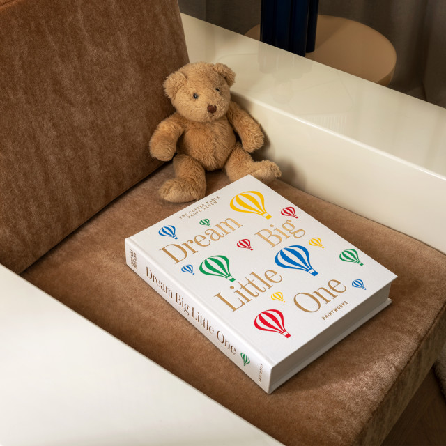 Printworks Dream Big Little One Baby Album - Beige next to a teddy bear