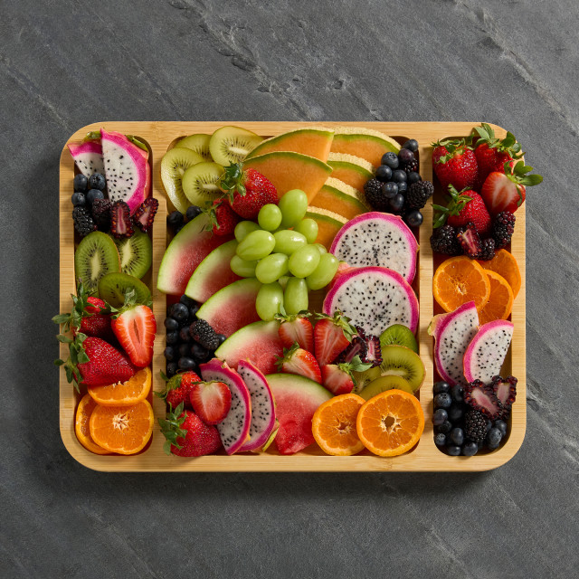 Farberware Build-a-Board Bamboo Rectangular Board - 30.5cm on the table with fruits