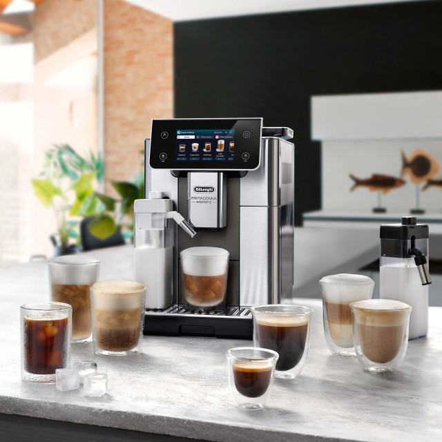 DeLonghi PrimaDonna Aromatic Bean to Cup Coffee Machine, ECAM630.75.TM on the kitchen island with cups of coffee
