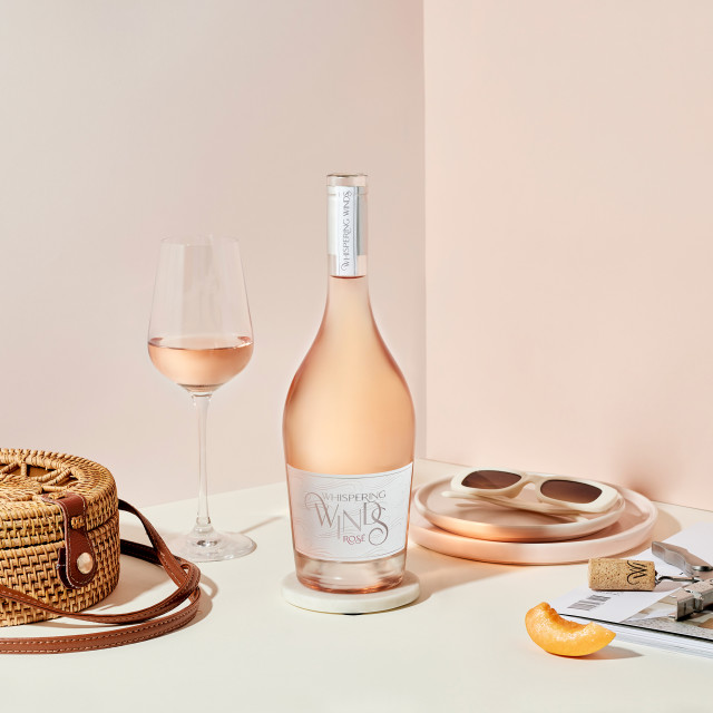 Whispering Winds Rosï¿½ in Gift Box on the table with a glass