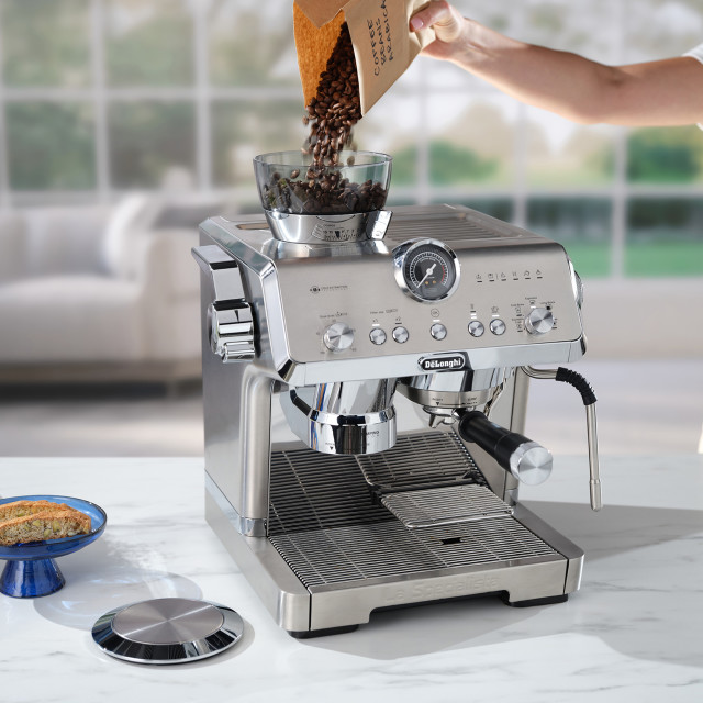 DeLonghi La Specialista Opera Manual Pump Espresso Coffee Machine, EC9555.M on the kitchen island with coffee beans