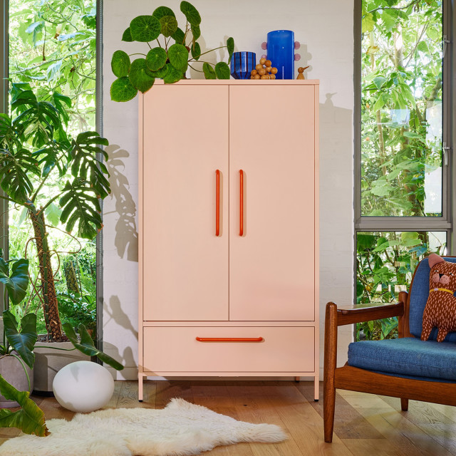 Popstrukt Sprinkles Double Locker - Peach Pop next to a chair with plants