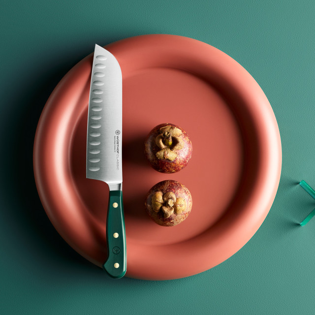 Wusthof Classic Colours Rosemary Hollow Edge Santoku, 17cm on a plate