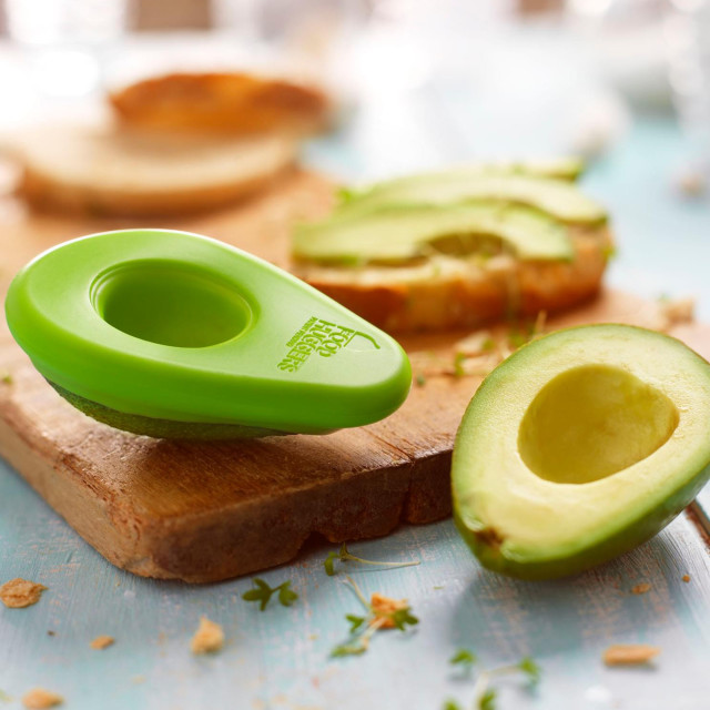 Food Huggers Avocado Huggers, Set of 2 on a board with avo