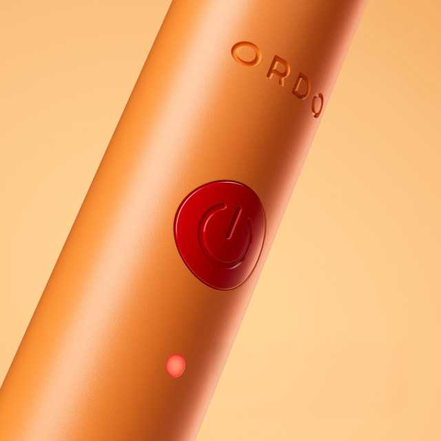Ordo Sonic Edge Rechargeable Toothbrush - Peach Sunrise on/off button close up