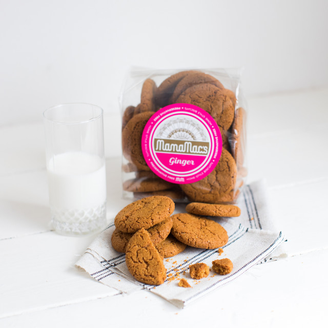 Mamamac's Ginger Biscuits open next to a glass of milk