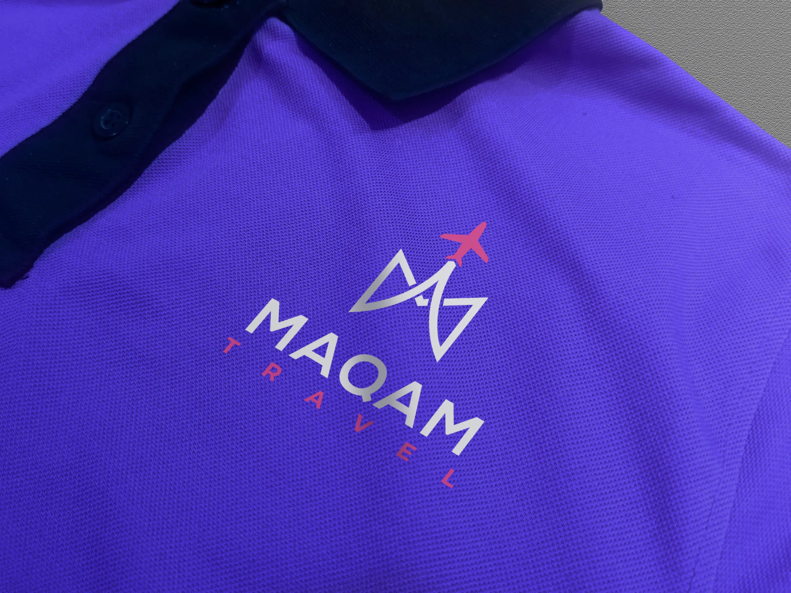 Gros plan du logo Maqam Travel brodé sur un polo