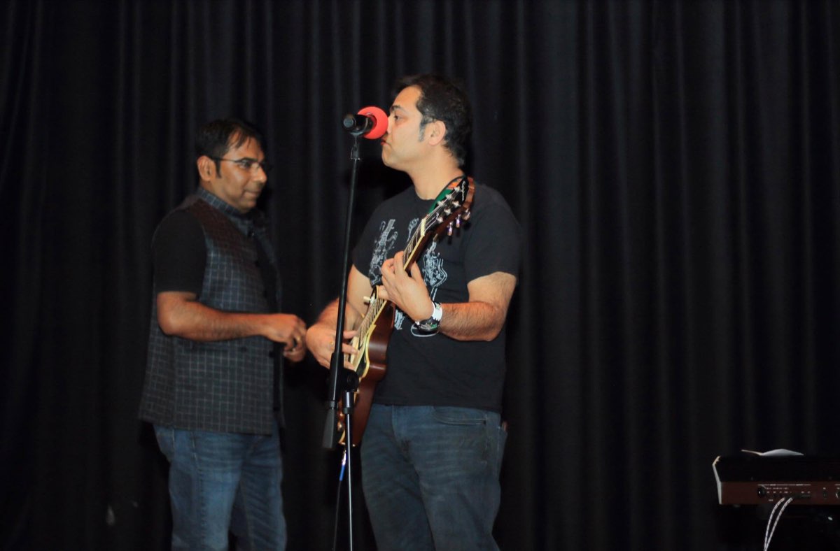 Two members sharing a moment at a live music performance