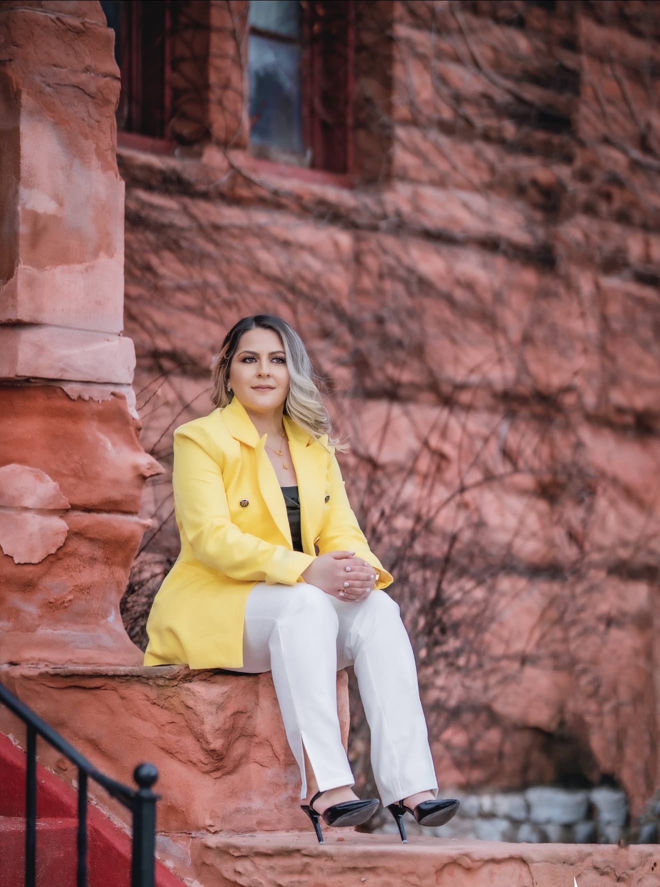Indiana Hannosh seated in a yellow jacket