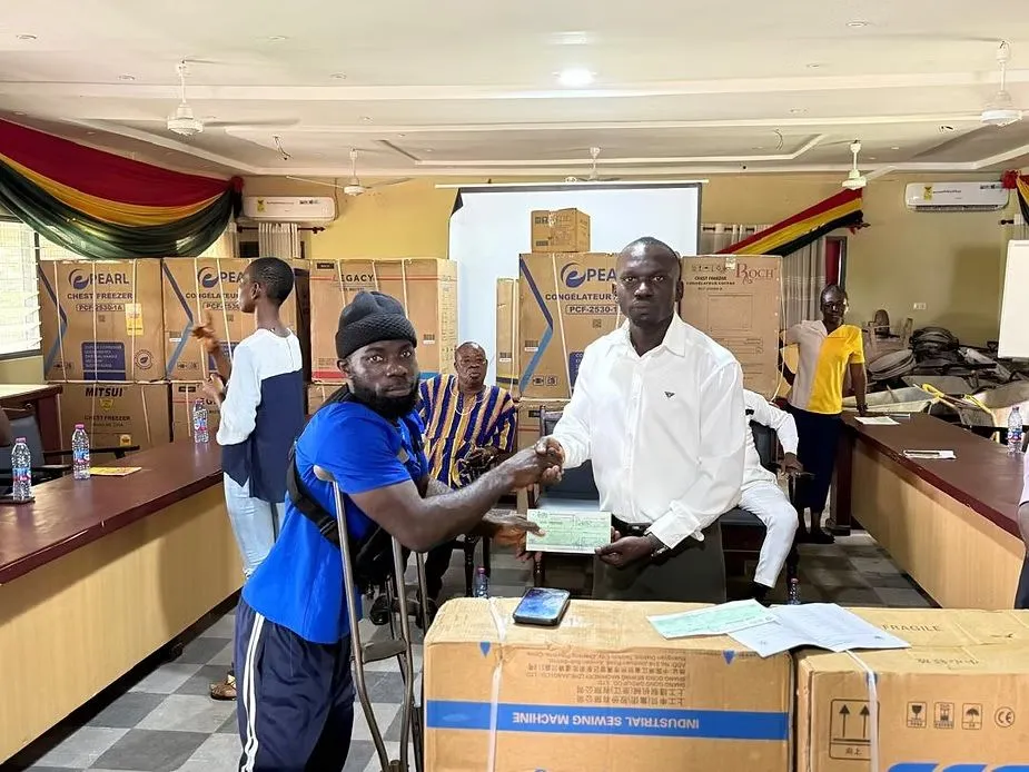 Hon. Dominic Gyasi presenting livelihood equipment and assistive devices to persons with disabilities