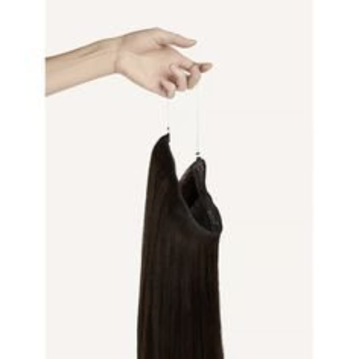 Hand holding a long dark brown straight hair weft by its string, against a plain light background.