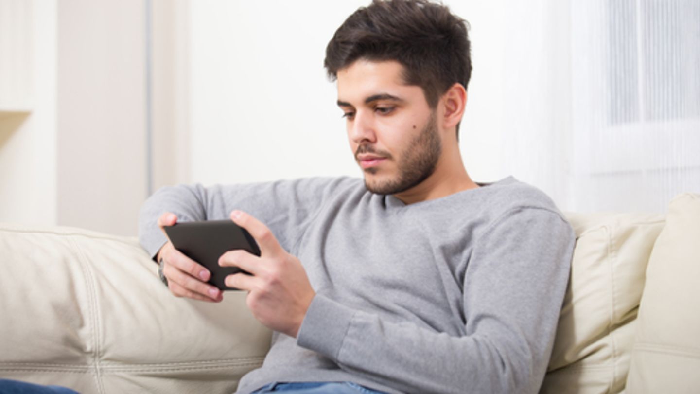 Man on his phone looking up the meaning of erectile dysfunction