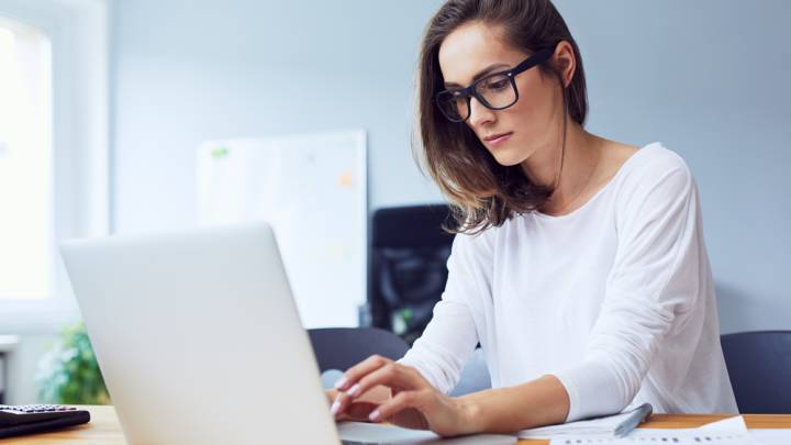 Woman looking up what herpes is on her laptop