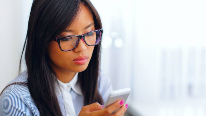 Women looking up herpes in women on her smartphone