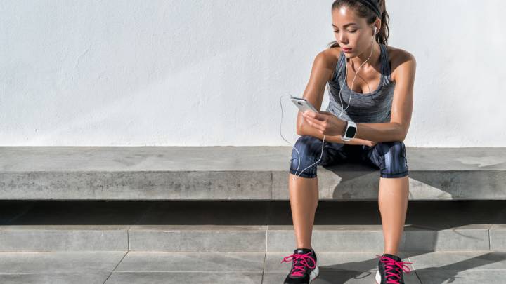 Woman reading about the herpes rash on her smartphone after going jogging