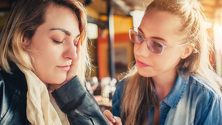 Woman with endometriosis discusses her experiences with a friend inside a restaurant